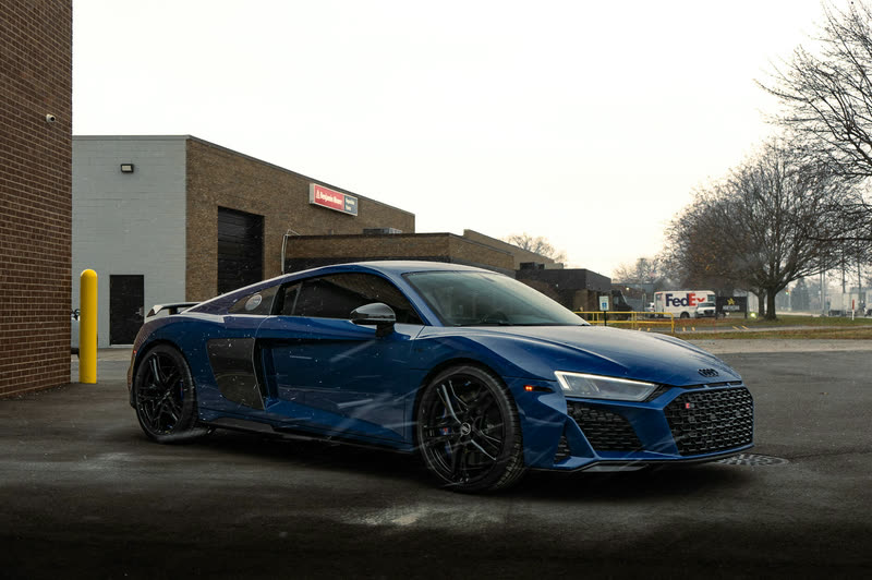 Blue Audi R8 on an asphalt lot