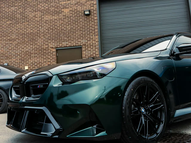 Dark green BMW M5, front corner view