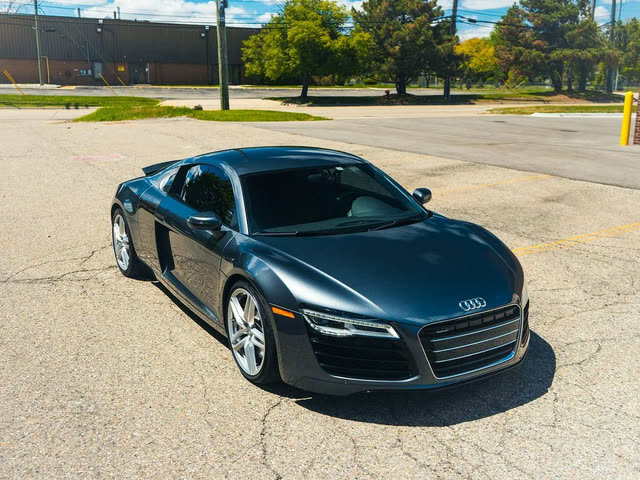 Dark grey Audi R8 parked in a lot