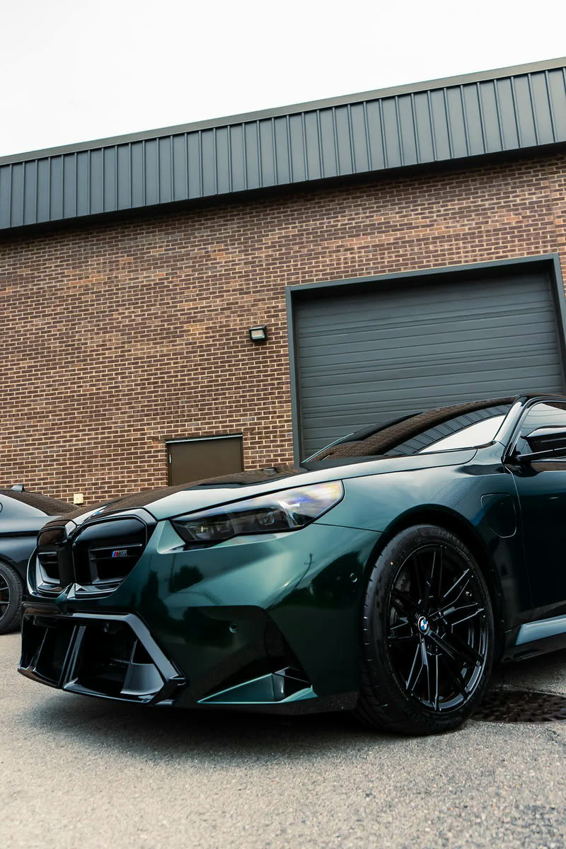 Dark green BMW M5, front corner view