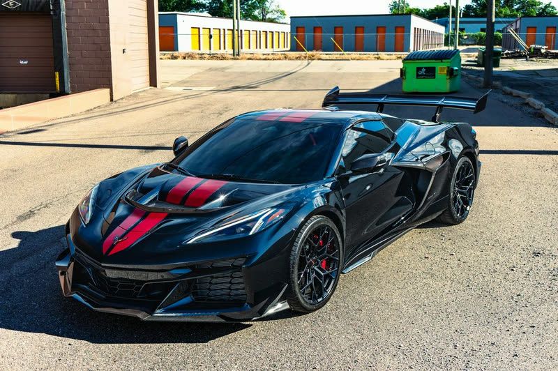 Black Corvette ZR1 with red stripes, front three-quarter view