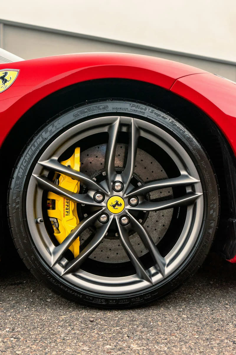 Close-up of a Ferrari wheel with a yellow brake caliper