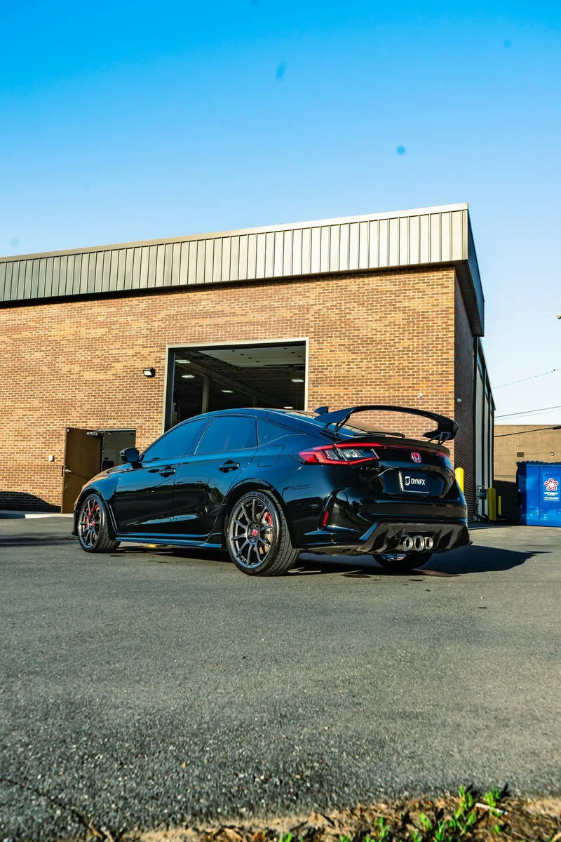 Dark blue Honda Civic Type R parked beside a brick building